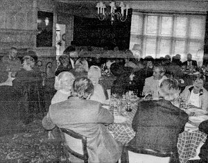 The dining room was set with five round tables.